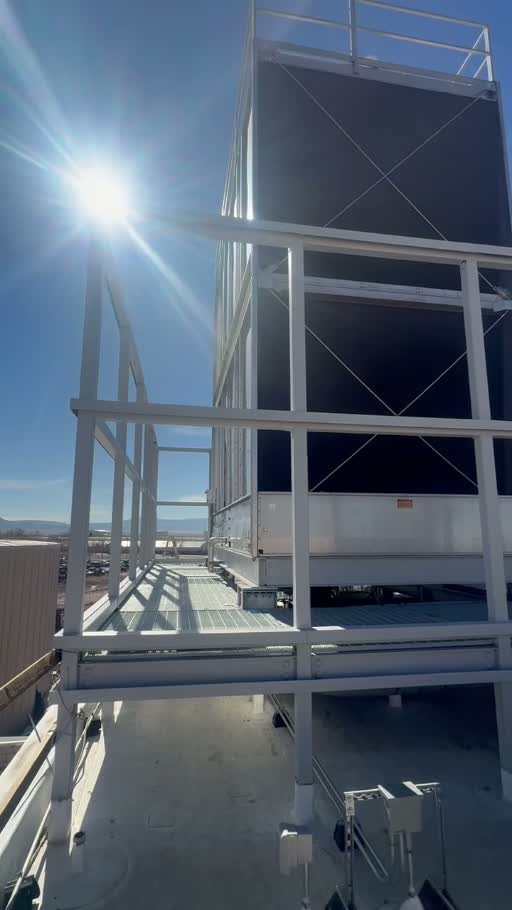 Rooftop equipment screen and steel access platform under clear sky