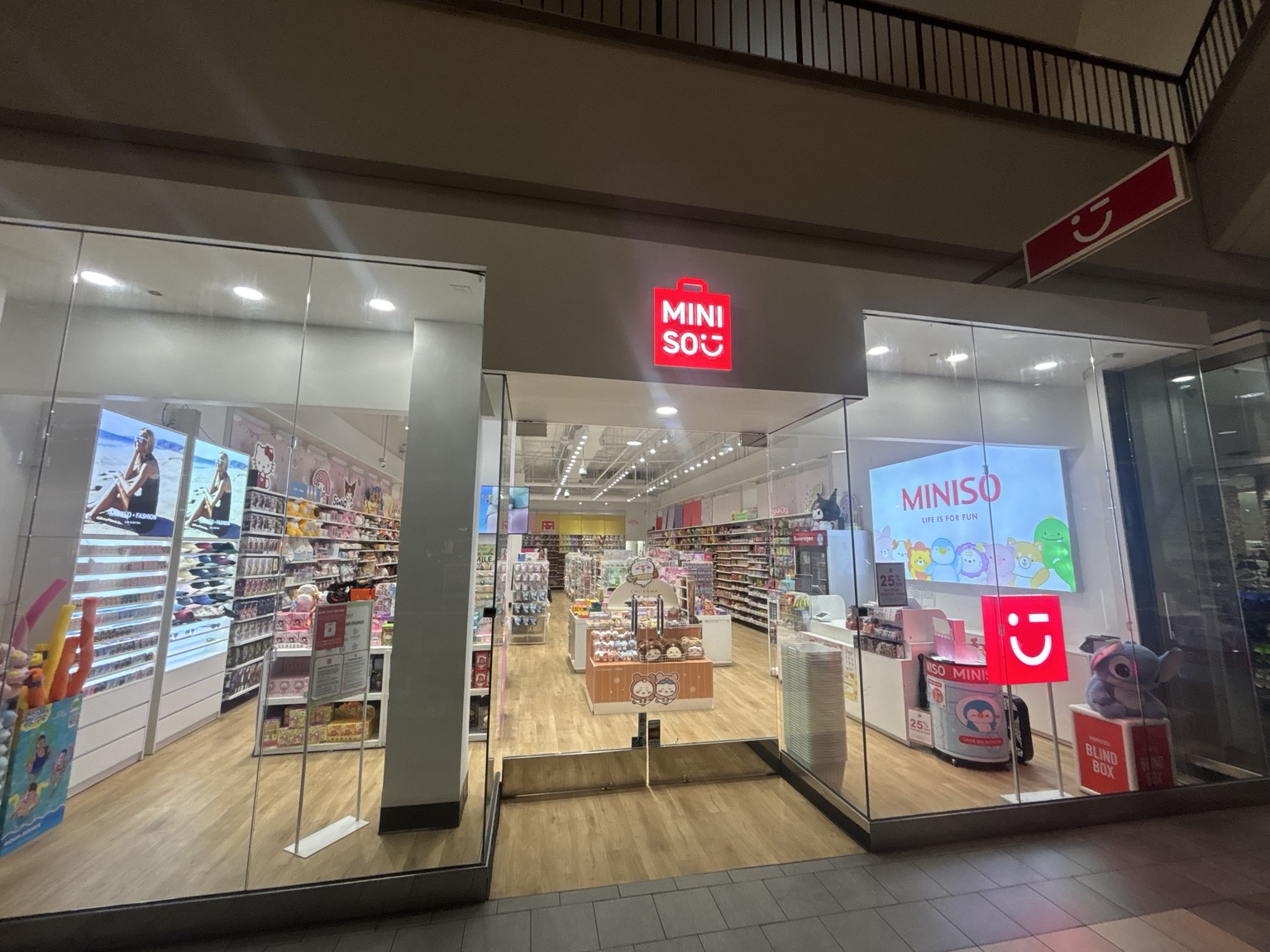 Completed MINISO retail storefront with illuminated signage and glass entrance