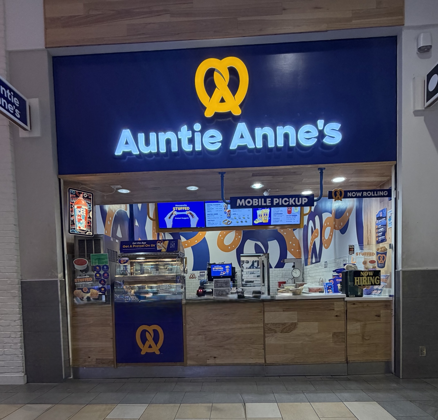 Completed Auntie Anne's storefront with illuminated signage